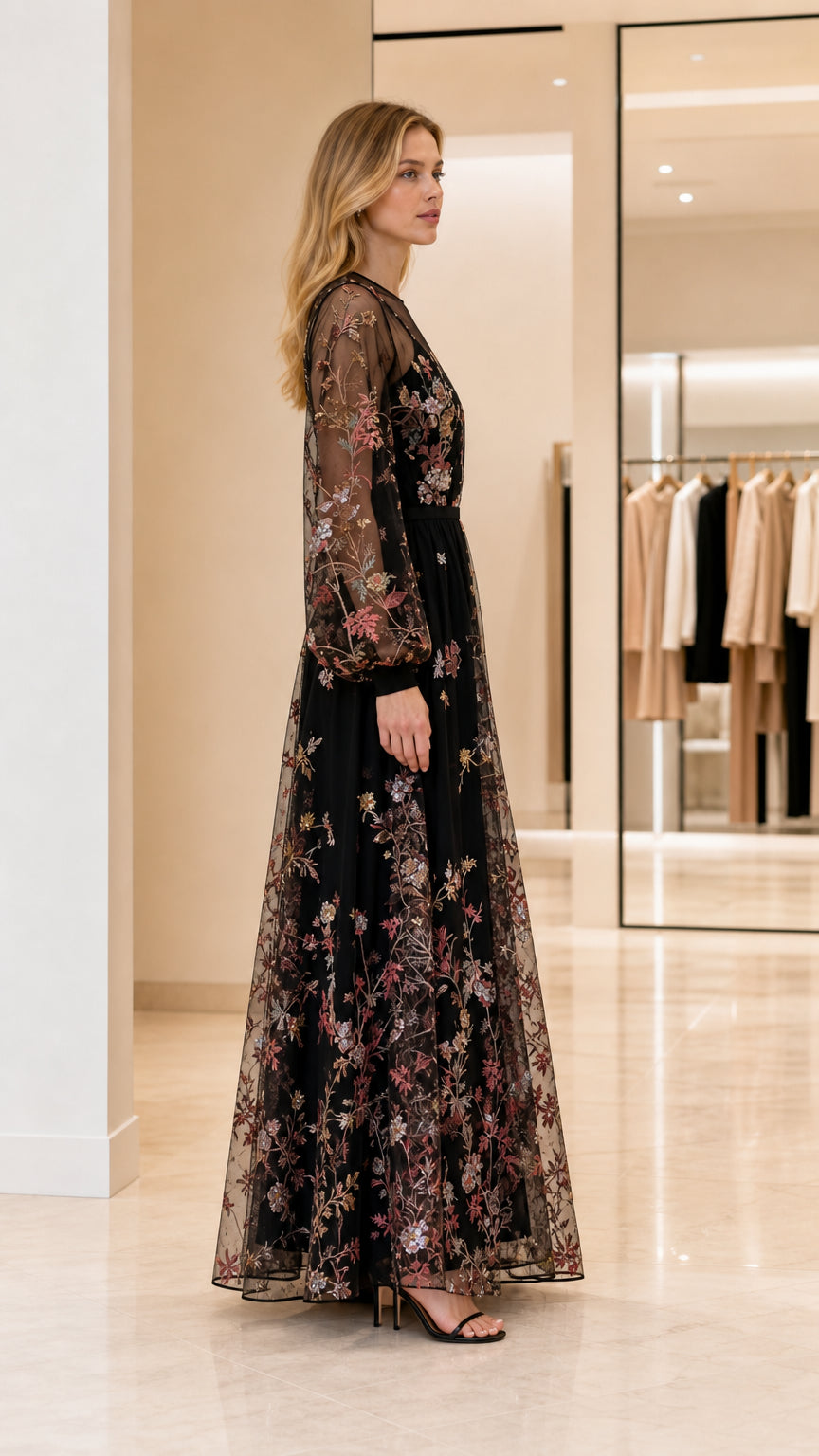 Side profile view of woman in black embroidered maxi dress