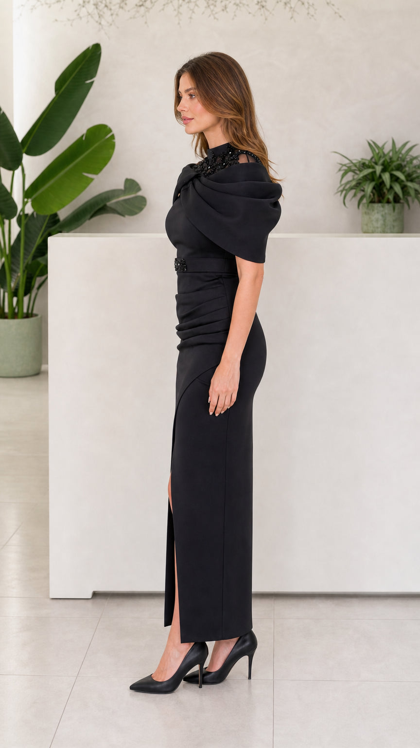 Side view of Black draped shoulder evening dress with front slit