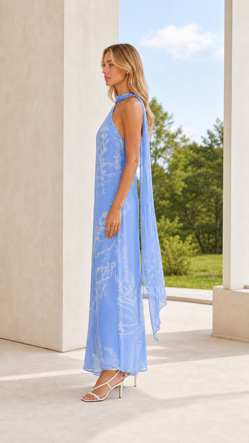 Side profile of model in light blue floral maxi dress with scarf detail