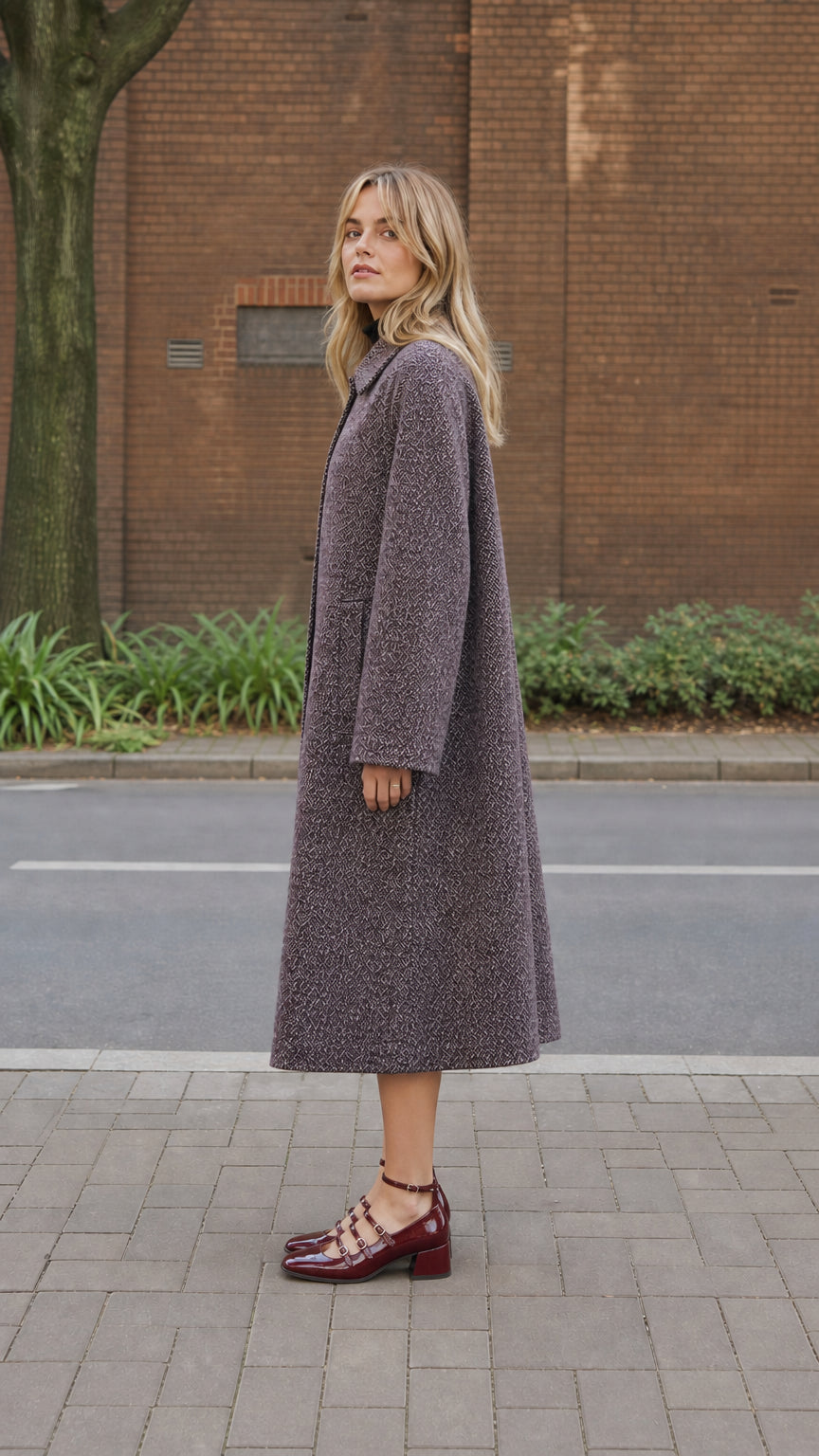 Side profile view of women's longline textured overcoat in Plum