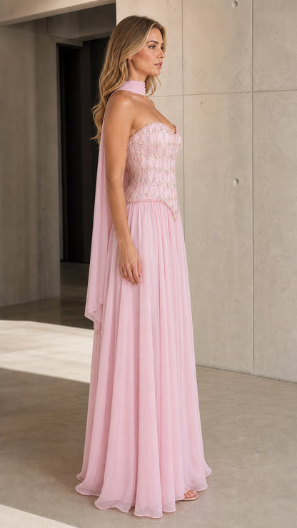Side view of model wearing Light Pink embellished strapless evening dress with neck scarf