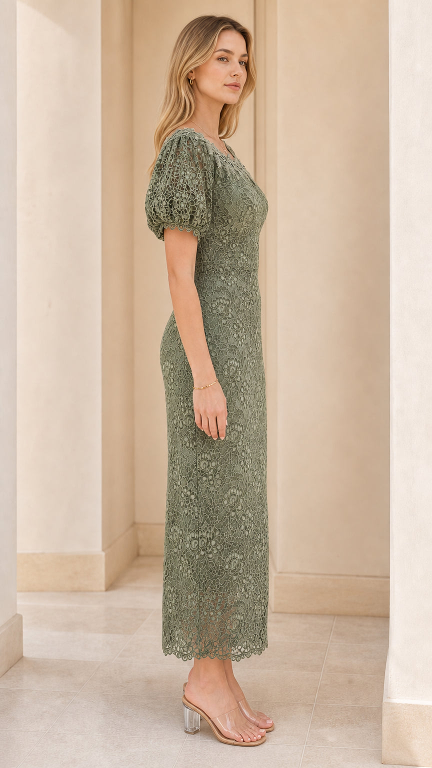 Side profile view of woman modeling sage green lace column dress