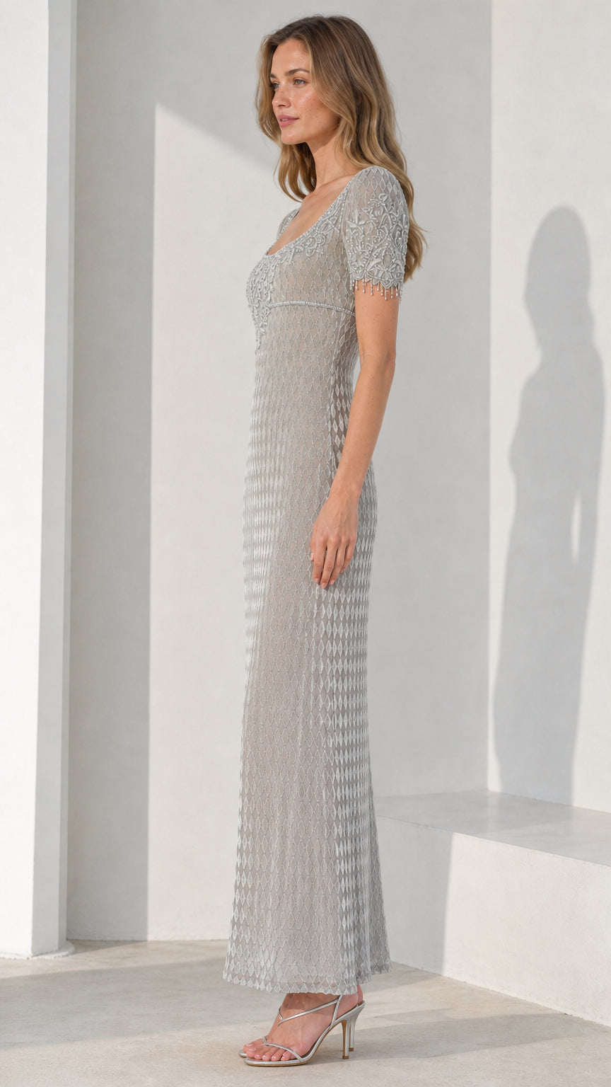 Side view of model wearing silver beaded evening dress