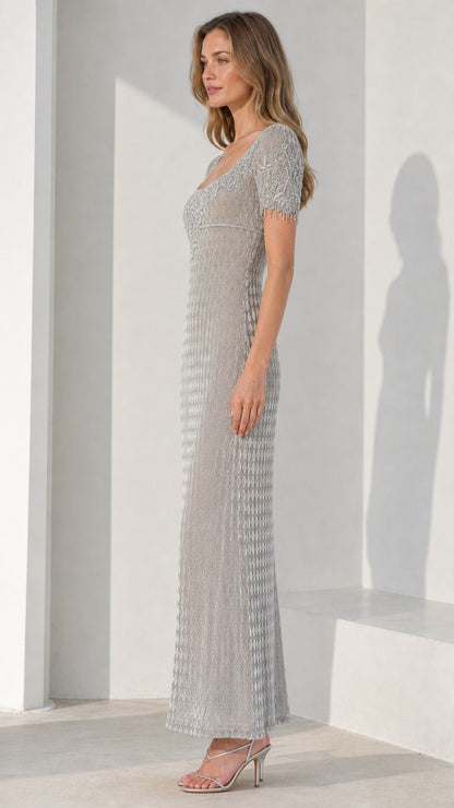 Side view of model wearing silver beaded evening dress