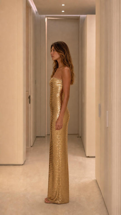 Side profile of model wearing gold sequin dress