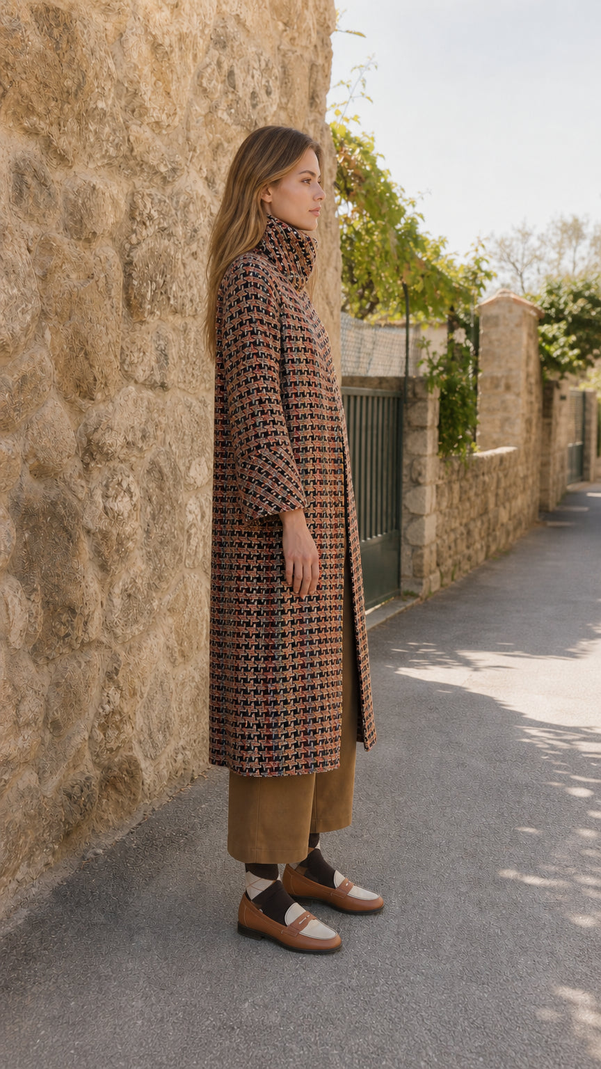 Side profile view of model wearing rust multi textured tweed long duster coat