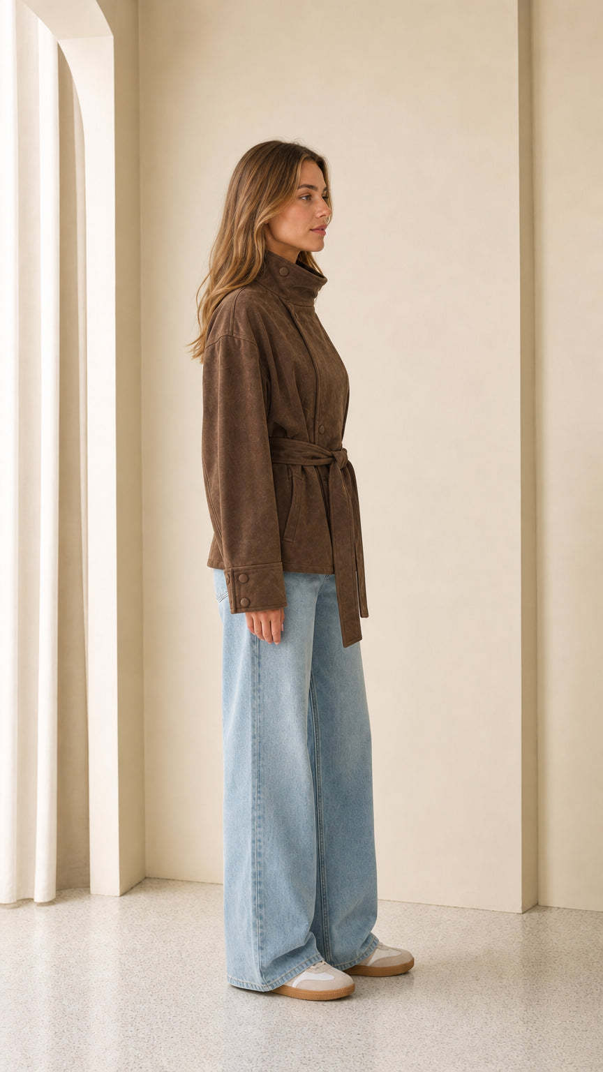 Woman wearing brown faux suede jacket side profile view