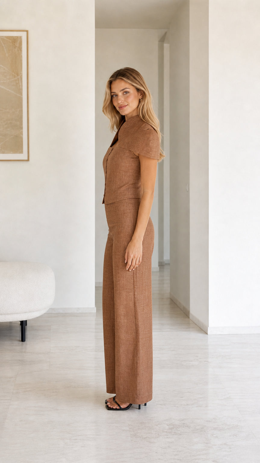 Side profile view of model in brown matching outfit