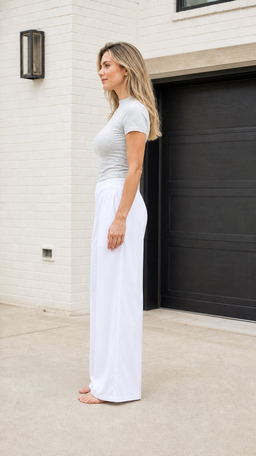 Model wearing white wide leg casual trousers side view