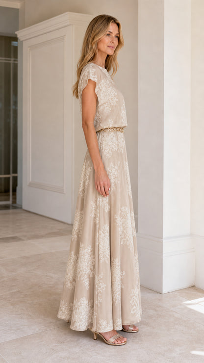 Model wearing Champagne floral embroidered maxi dress from the side view