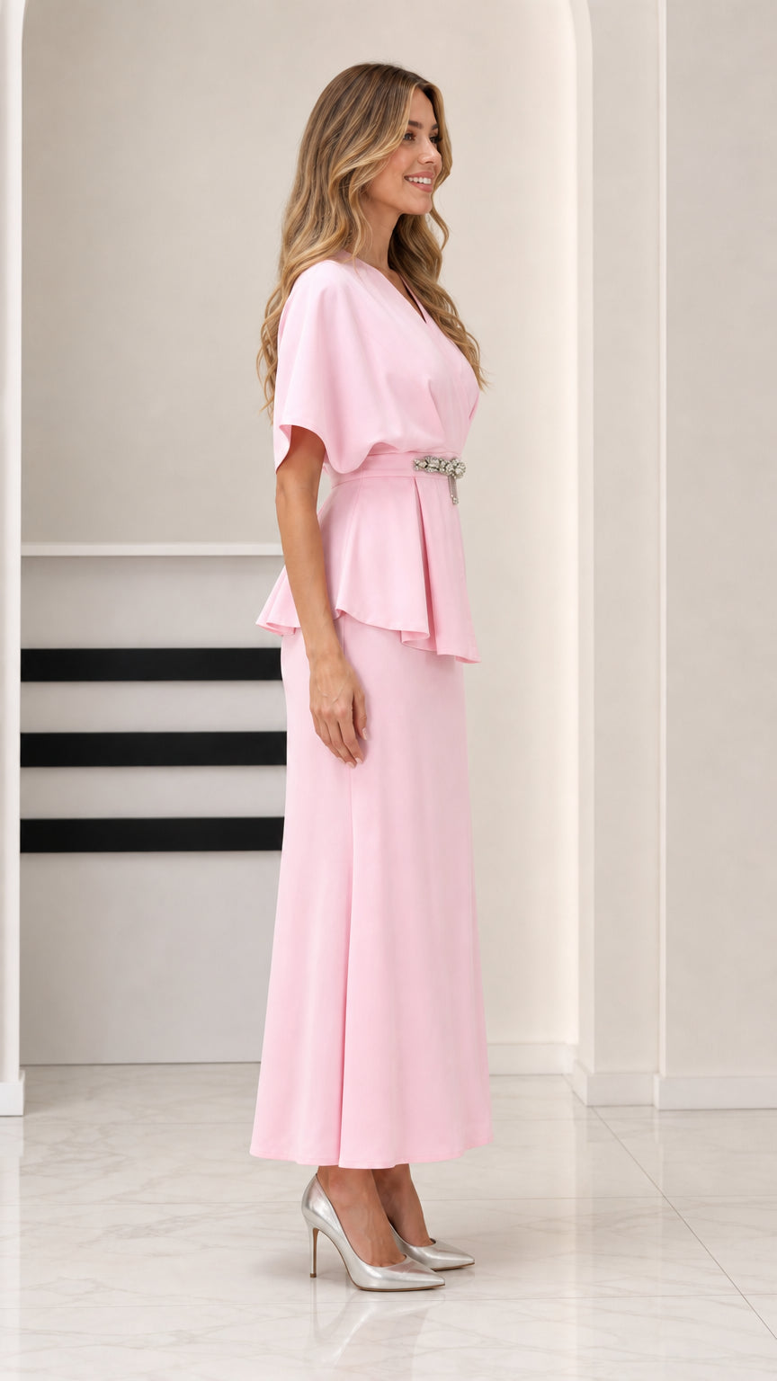 Side angle view of model in Light Pink formal peplum maxi dress