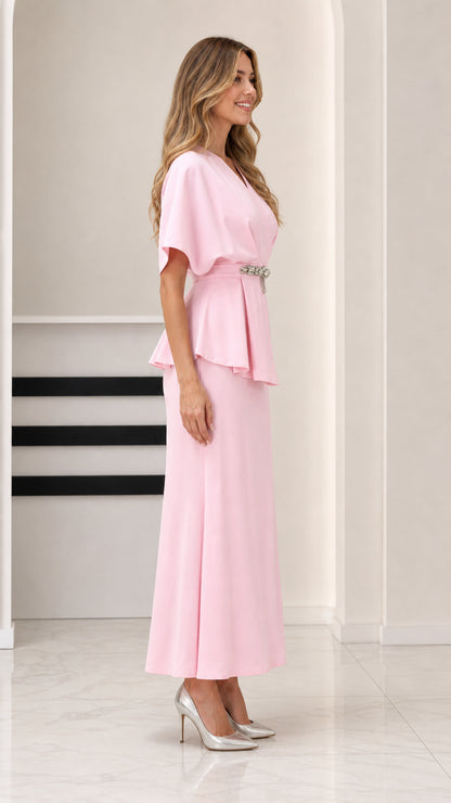 Side angle view of model in Light Pink formal peplum maxi dress