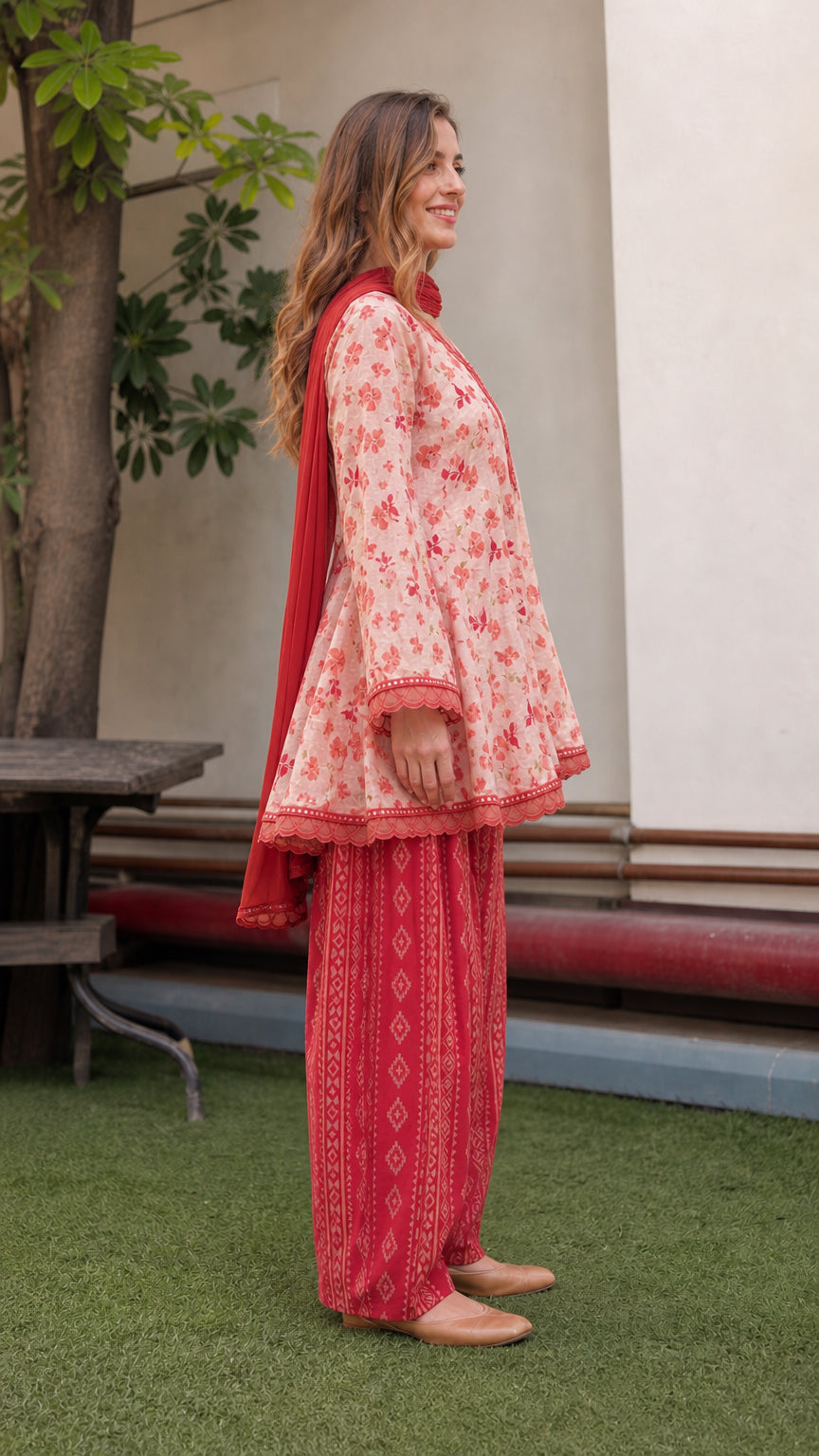 Side view of model wearing peach floral ethnic set