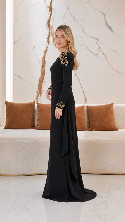 Side profile of black formal gown showing cascading side drape