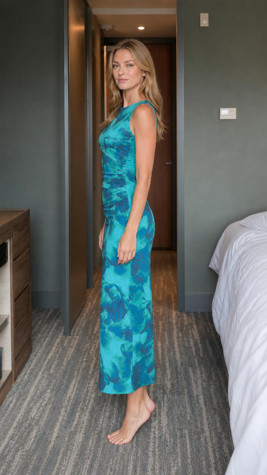 Side profile view of teal abstract print midi dress