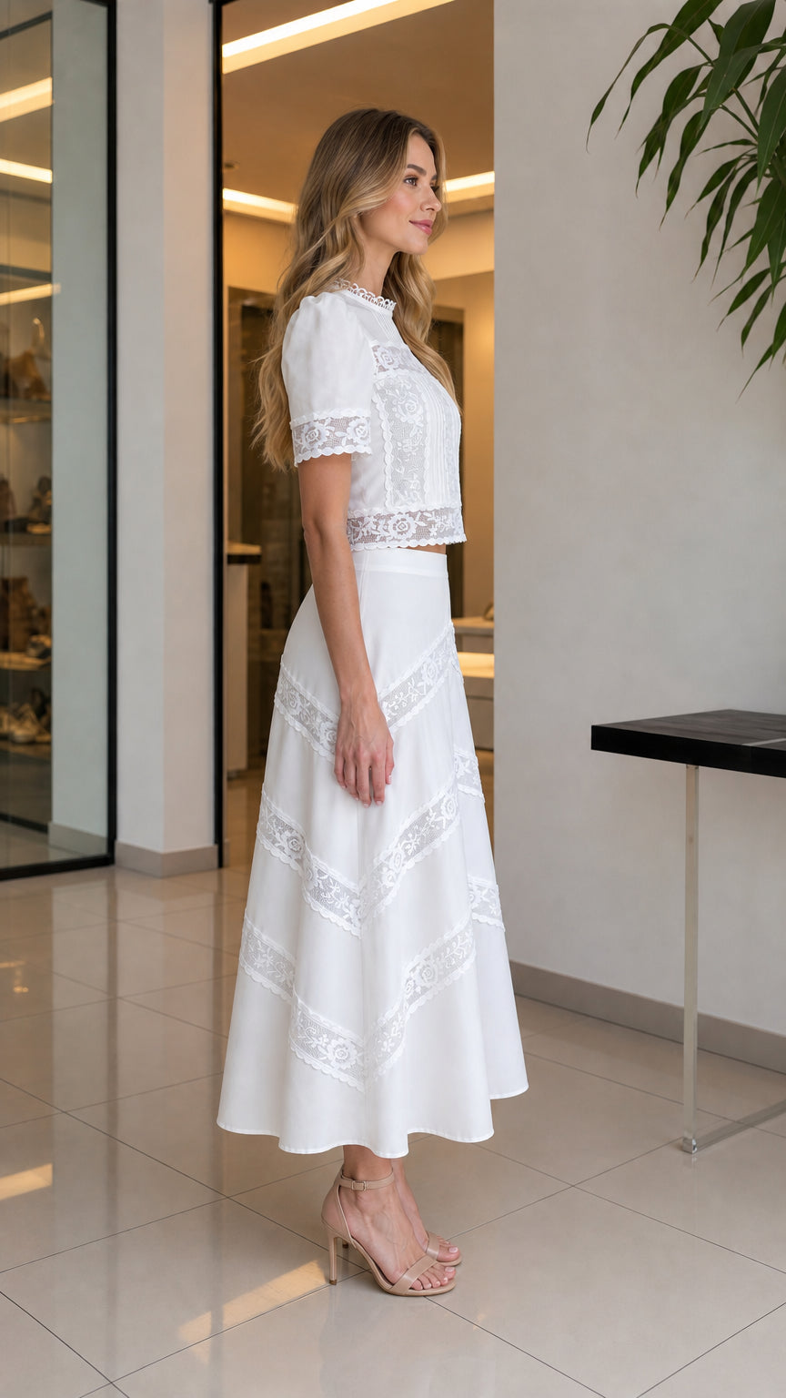 Side profile view of woman in white lace two-piece set with heels