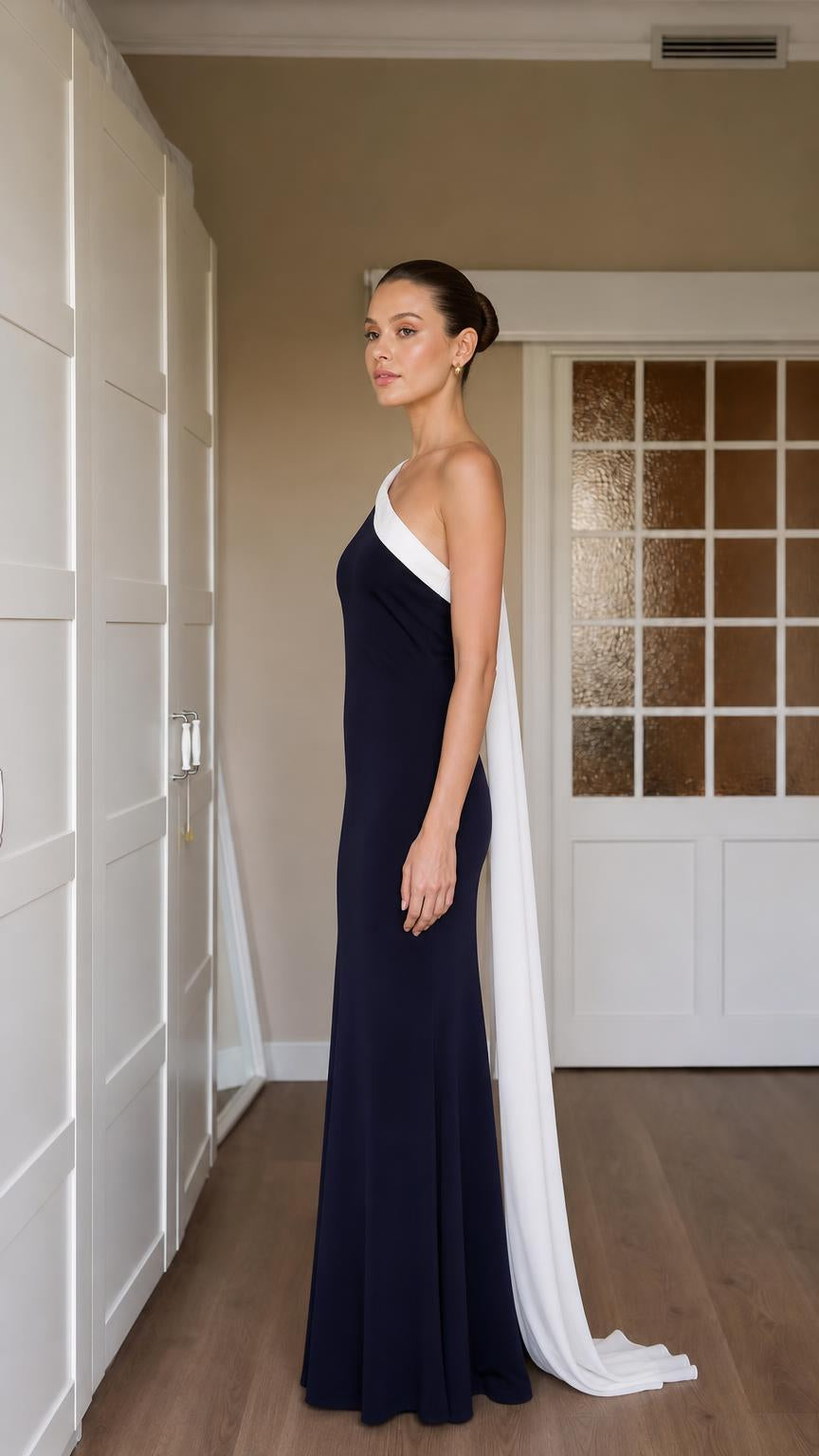 Side view showing draped sash and silhouette of navy gown