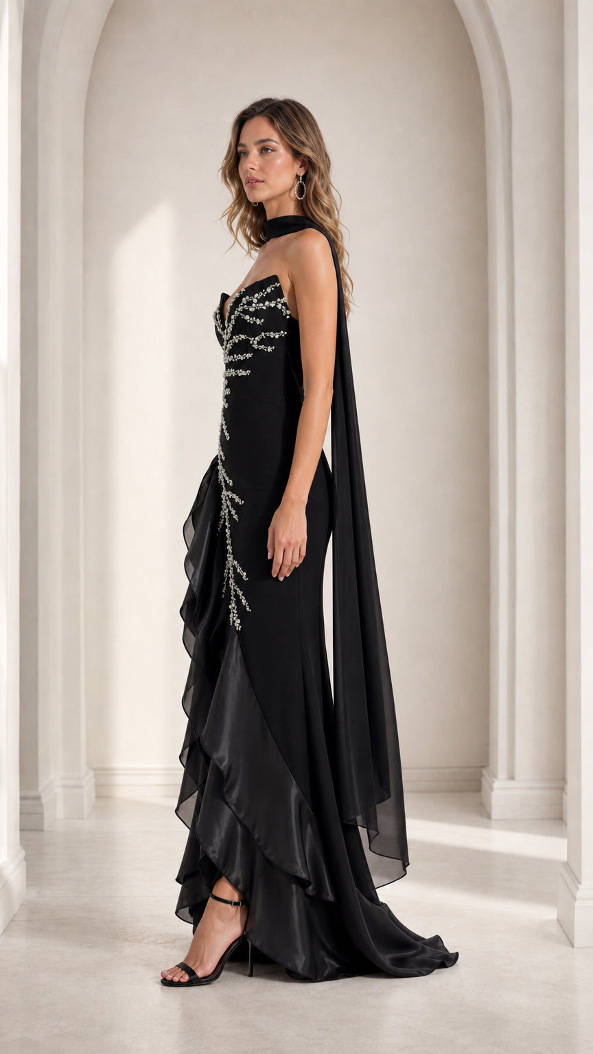 Black beaded formal evening dress side view showing silhouette and cascading cape