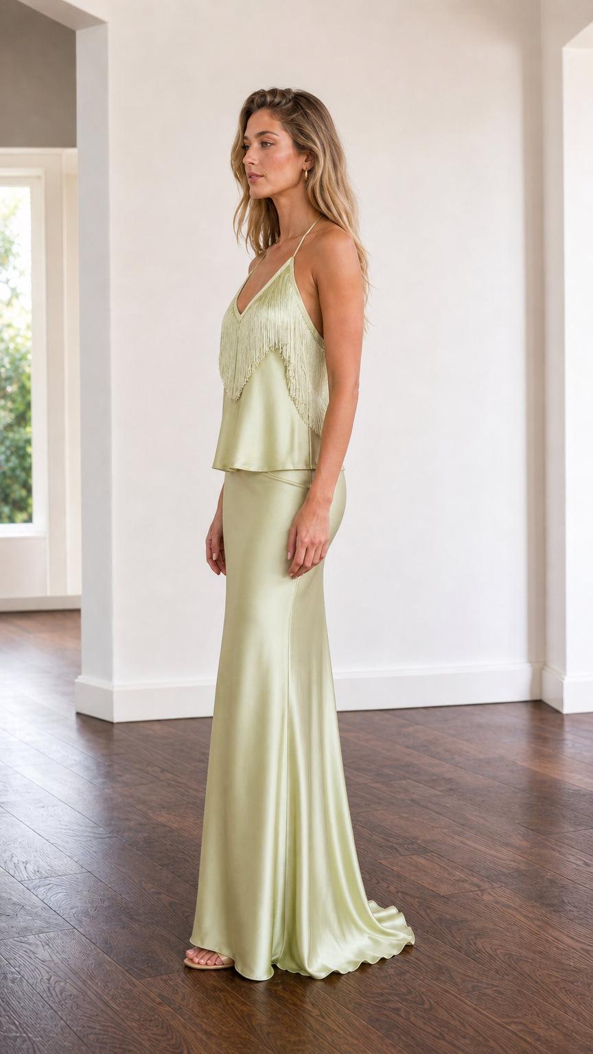 Side profile of model in sage green satin two-piece set