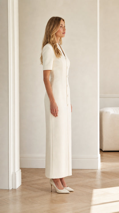 Side profile view of ivory tailored short sleeve maxi dress with button details