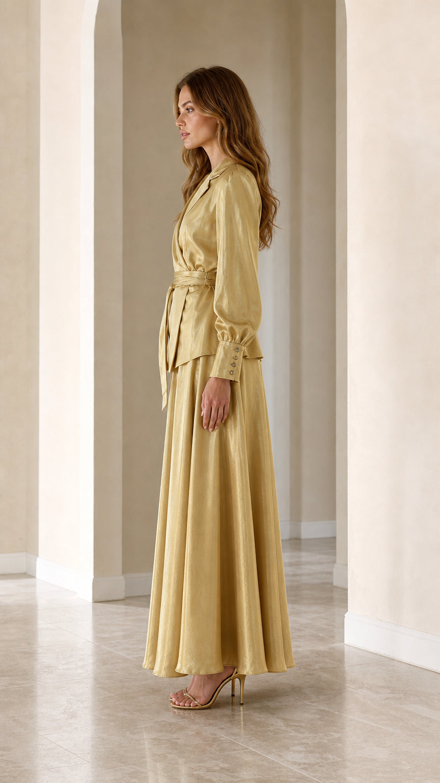 Side profile view of woman wearing Champagne Gold satin two-piece maxi set
