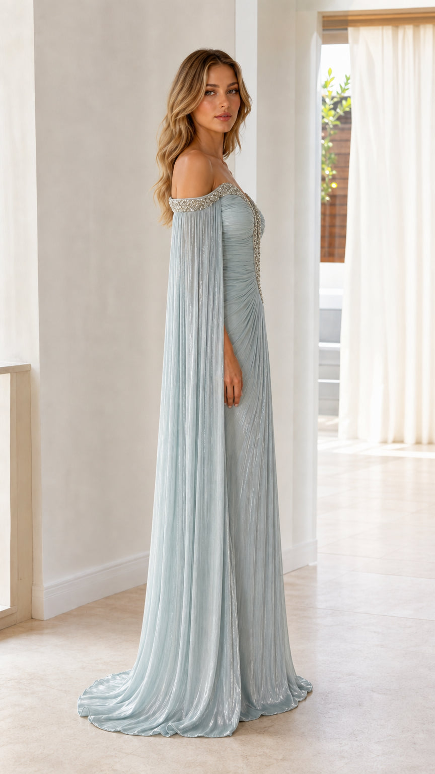 Side full-length view of woman in ice blue cape sleeve formal evening dress