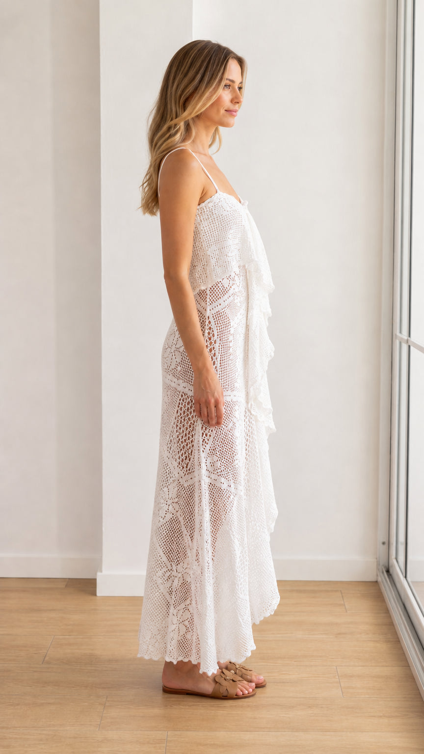 Side profile of model in white crochet maxi dress