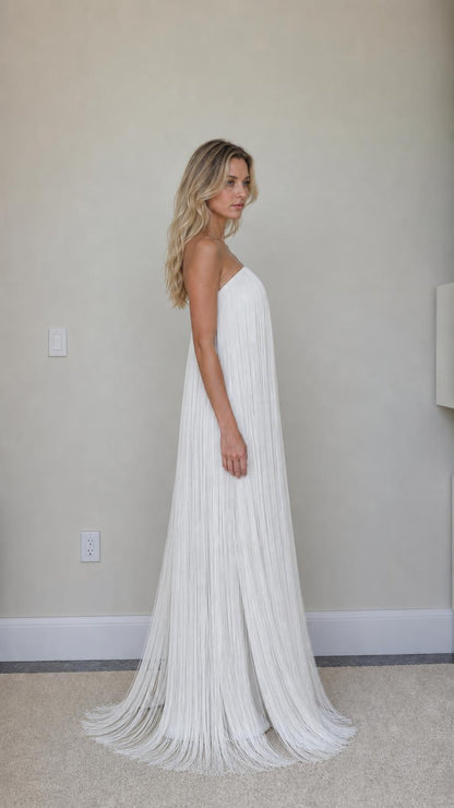 Side profile view of white fringe maxi dress