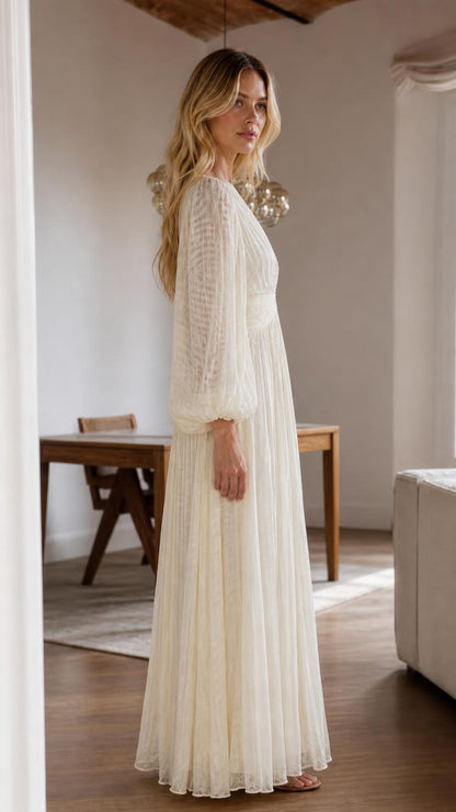 Side profile view of cream pleated maxi dress