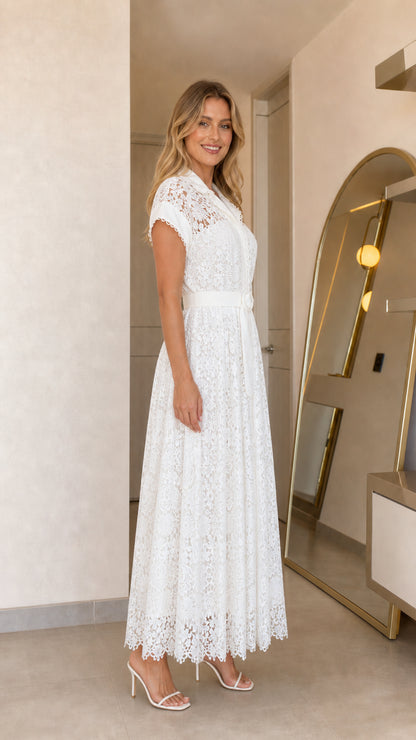 Side profile of woman wearing white lace maxi dress