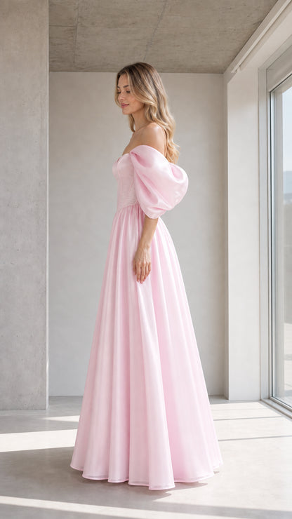 Side profile of model in pink evening dress