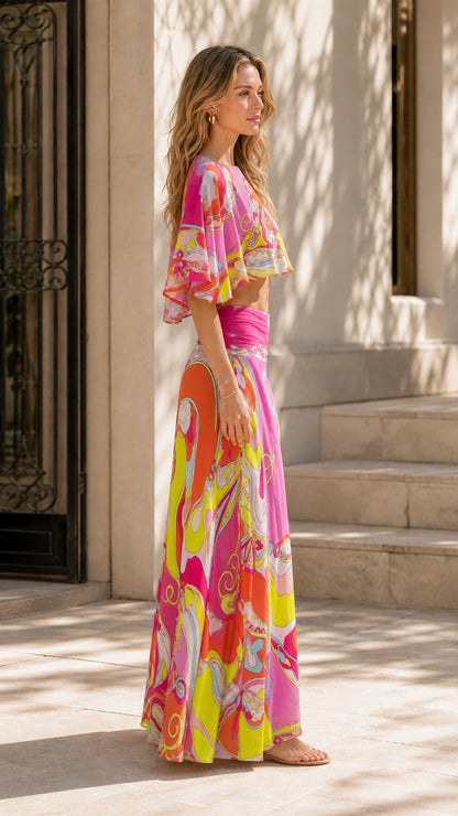 Side profile view of model in pink abstract print two-piece set