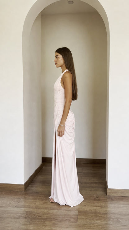 Side profile view of blush pink dress with high slit