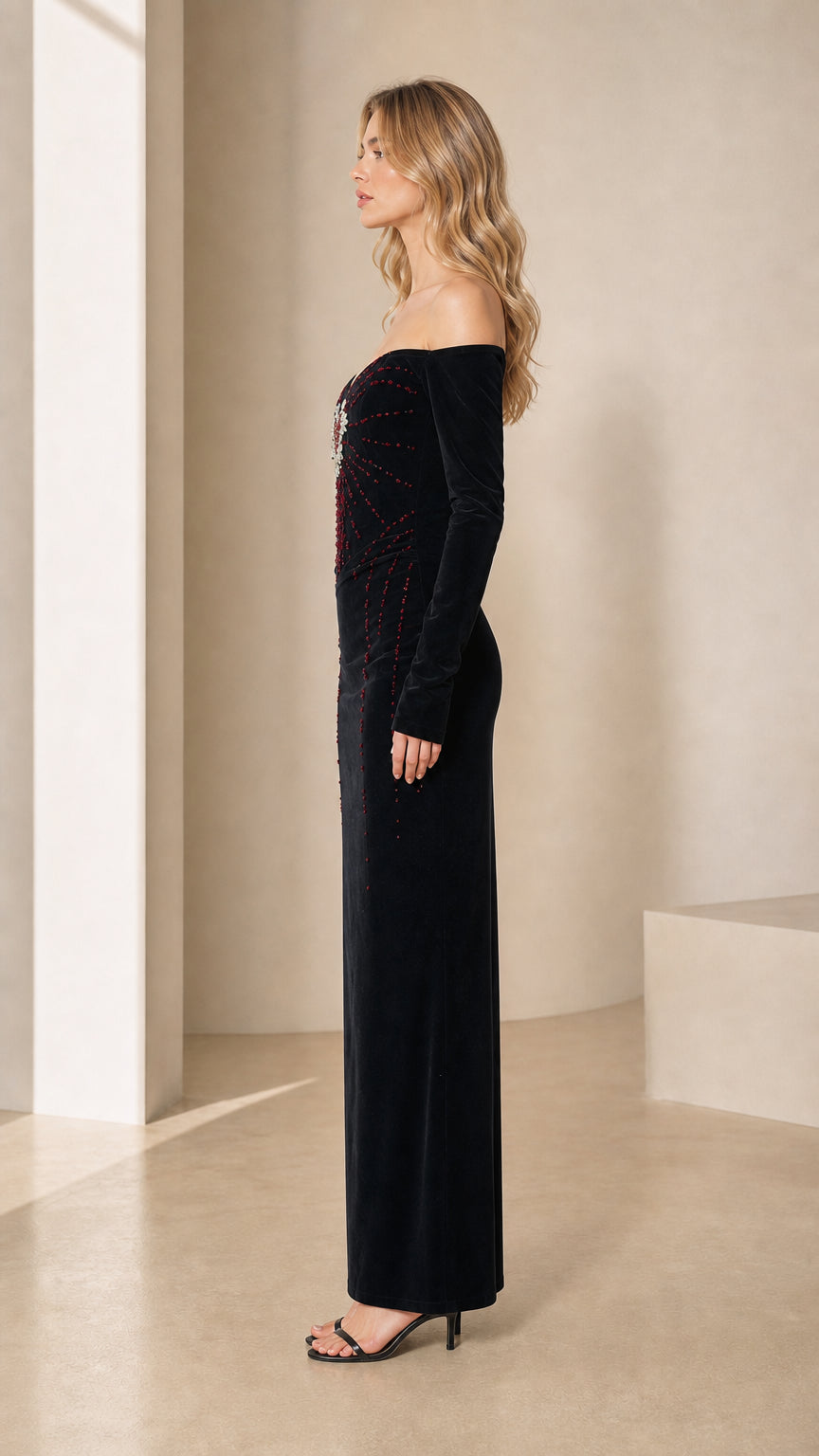 Side profile view of black velvet off-the-shoulder evening gown