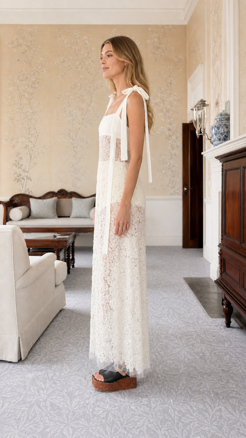 Side profile of white tie-strap lace maxi dress