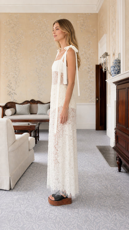 Side profile of white tie-strap lace maxi dress