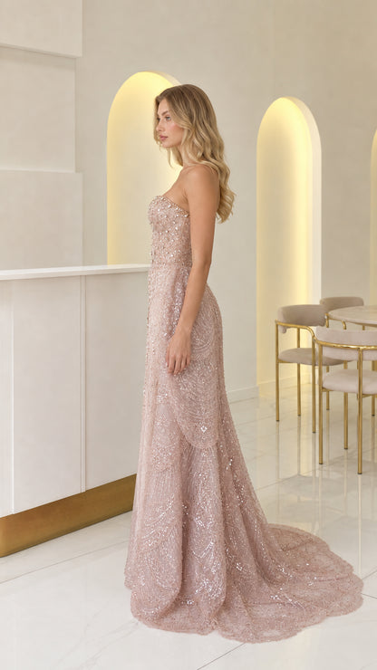 Side view of dusty rose embellished mermaid formal dress showing silhouette and train