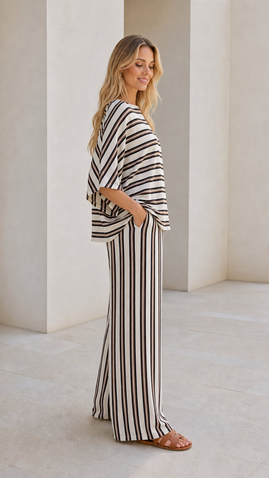 Model wearing beige striped set from side view showcasing pockets