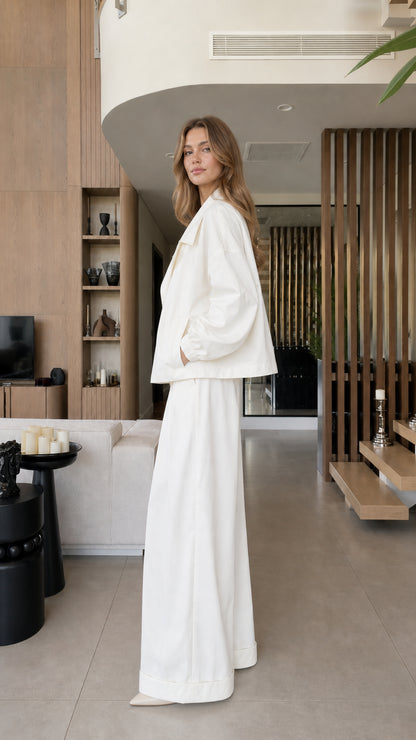 Side view showing the relaxed fit and fluid wide-leg silhouette of the white two-piece set