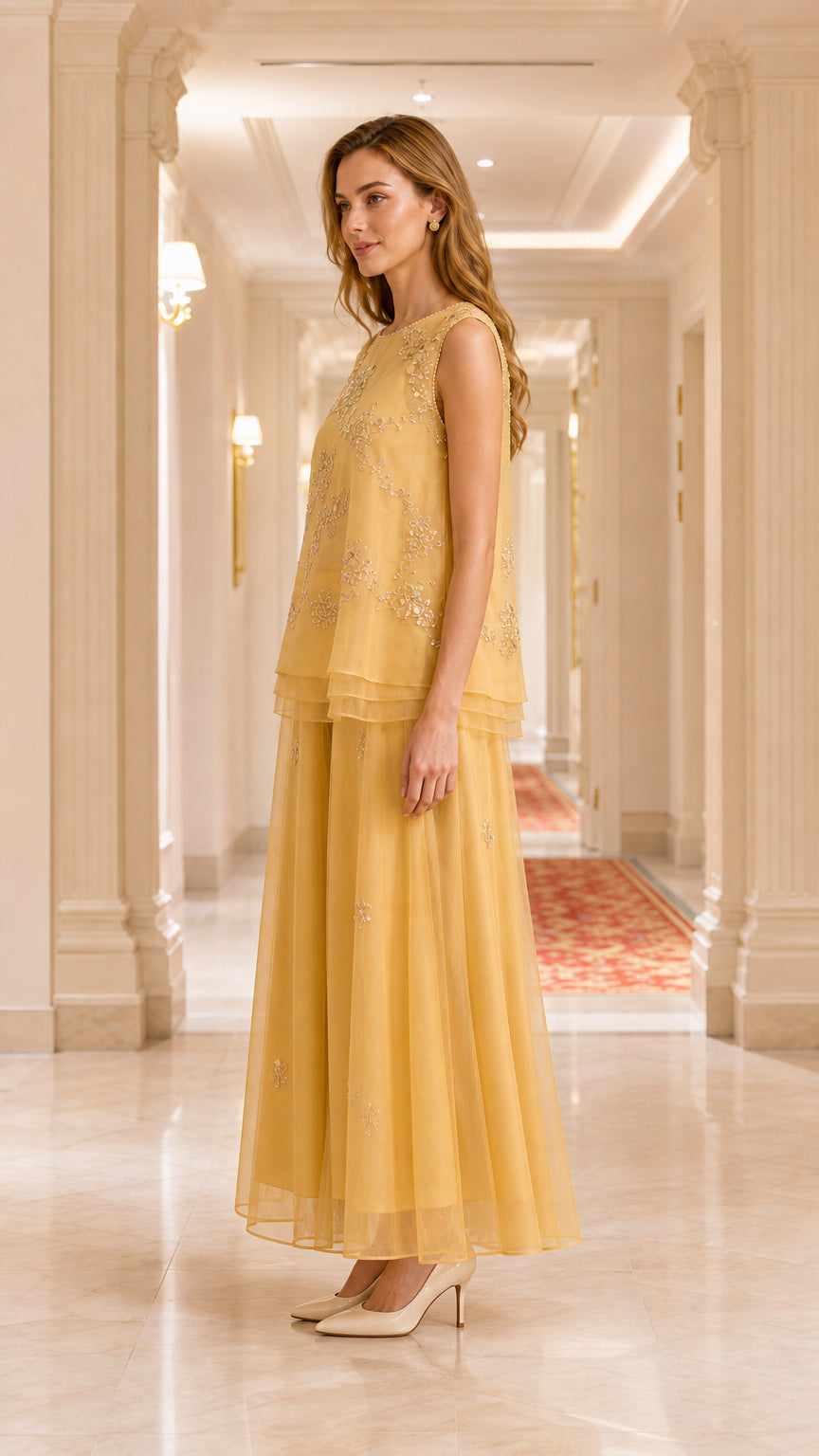 Side profile view of gold two-piece formal tunic and wide leg pant set