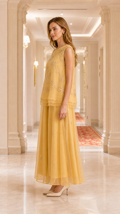 Side profile view of gold two-piece formal tunic and wide leg pant set