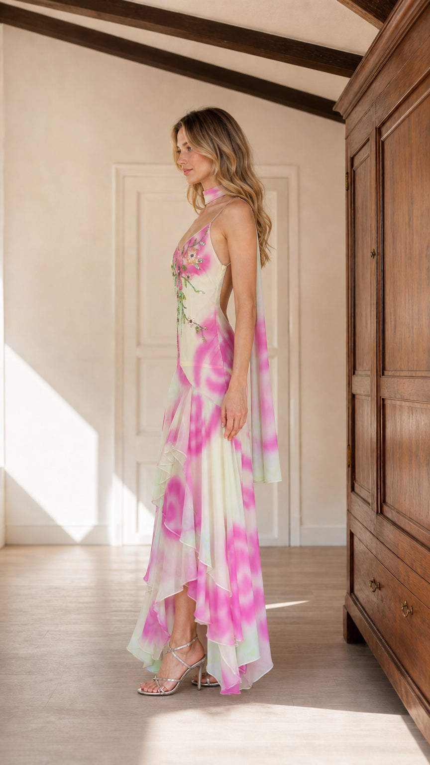 Side view of pink watercolor embroidered dress showing open back and tiered hem