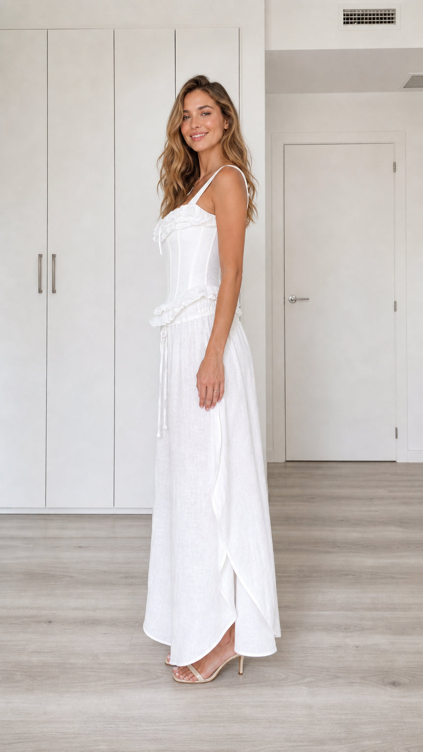 Model wearing white two-piece set, side view