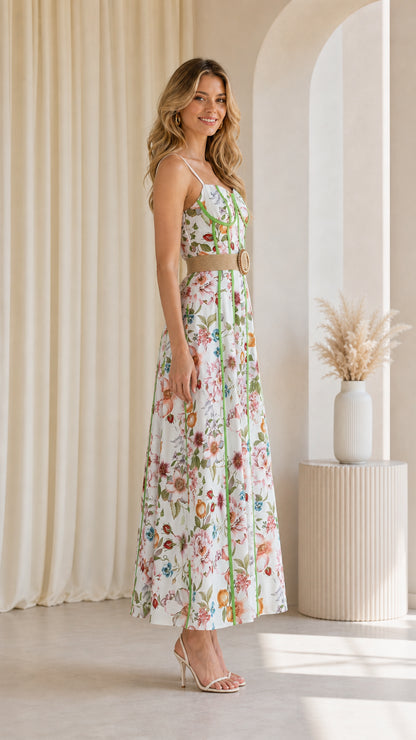 Side profile of model in white floral maxi dress
