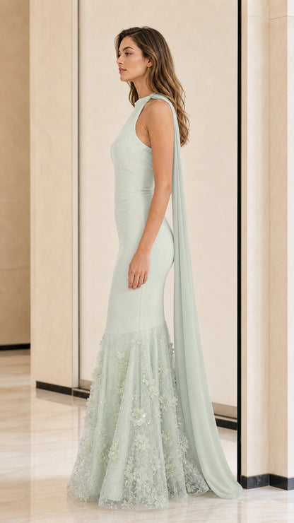 Side profile view of sage green formal gown with flowing cape