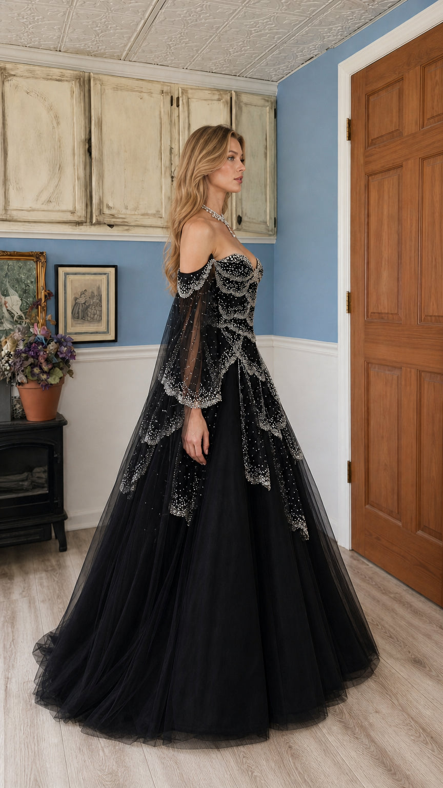 Side profile view of black beaded formal gown showing silhouette and sleeve drape