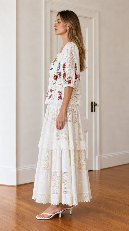 Side profile view of woman wearing white embroidered maxi dress