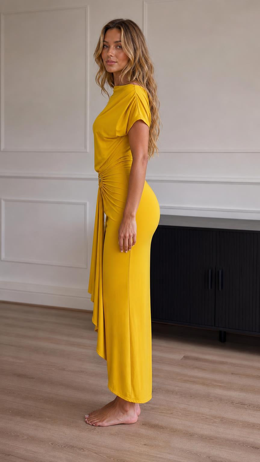 Side profile view of model in yellow maxi dress showcasing the drape