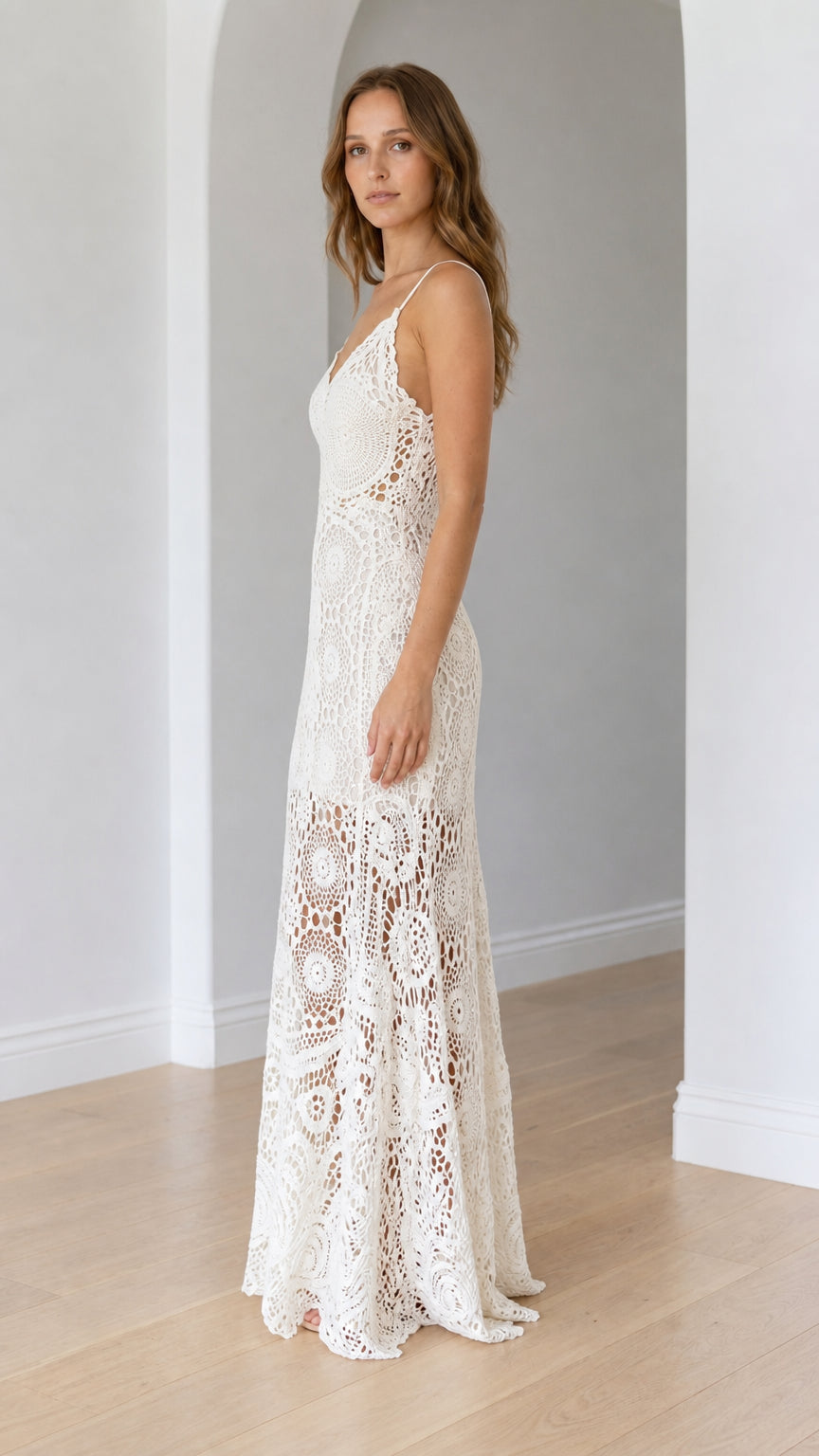 Side profile of ivory openwork knit maxi dress showing figure-skimming fit