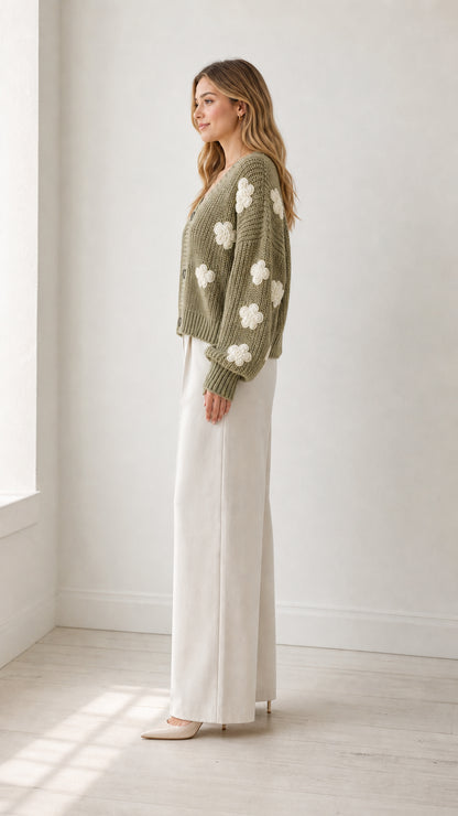 Side profile view of model wearing sage green flower appliqué cardigan sweater